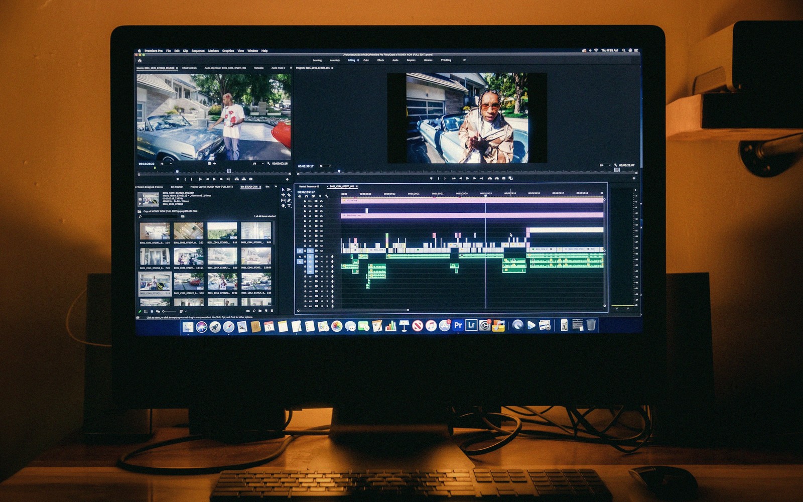Computer monitor displaying video editing software with timeline and preview clips of a music video